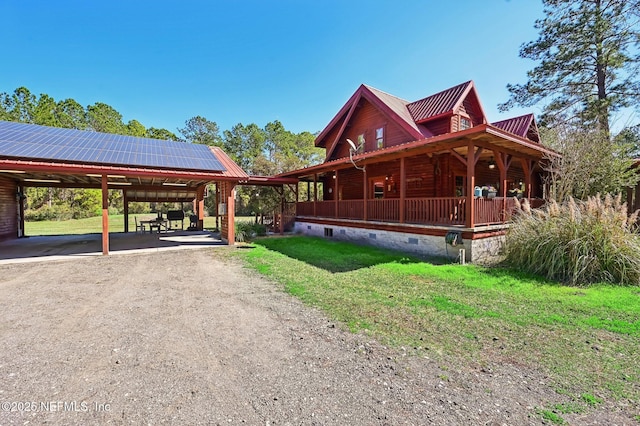 view of front of property with a front yard, solar panels, and covered porch