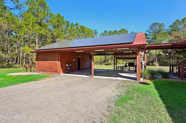 exterior space featuring a lawn and solar panels