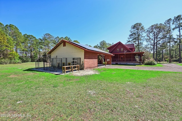 back of property with a lawn