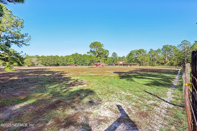 view of yard with a rural view