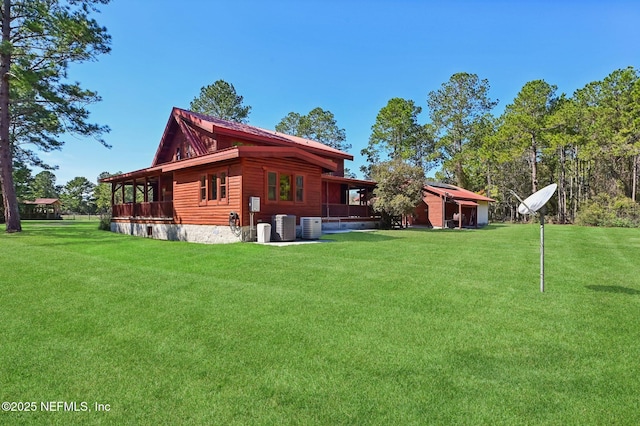 view of property exterior featuring a yard and central AC unit