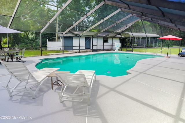 view of pool featuring glass enclosure and a patio area