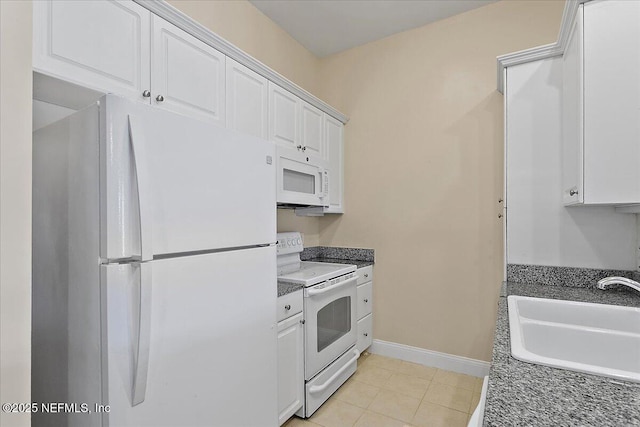 kitchen with white cabinets, white appliances, light tile patterned flooring, and sink