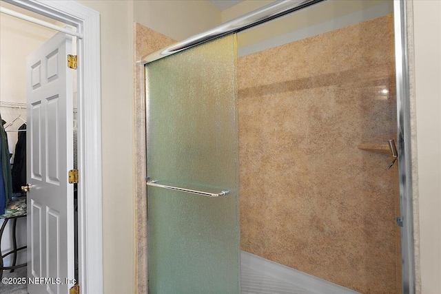 bathroom featuring a shower with door