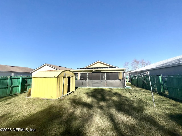 back of property featuring a sunroom and a yard