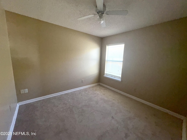 spare room with carpet flooring, ceiling fan, and a textured ceiling