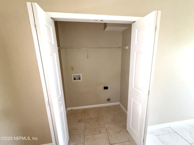 clothes washing area featuring hookup for an electric dryer, hookup for a washing machine, and light tile patterned flooring