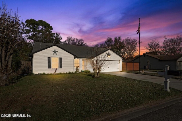 ranch-style home with a yard and a garage