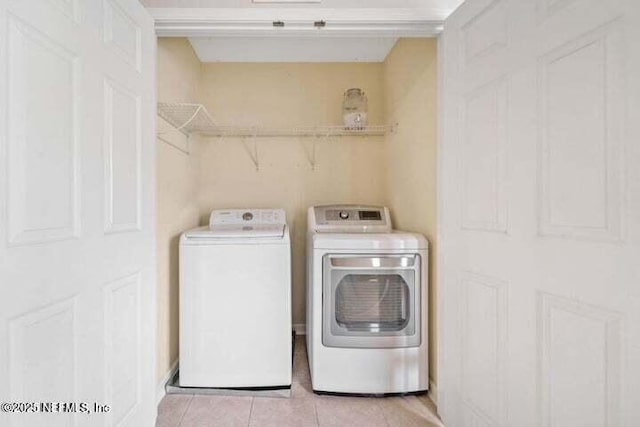 laundry area featuring independent washer and dryer and light tile patterned floors