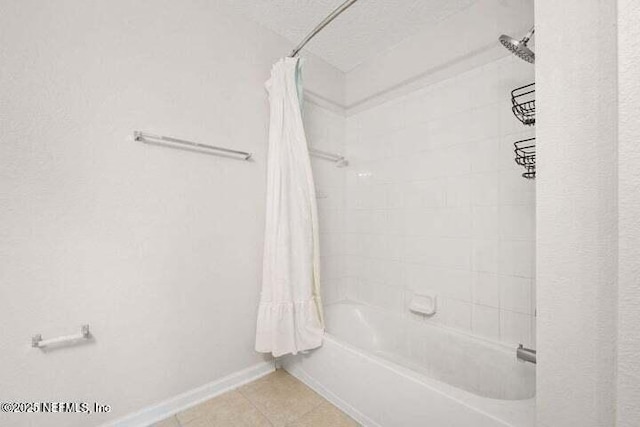 bathroom featuring a textured ceiling and shower / tub combo with curtain