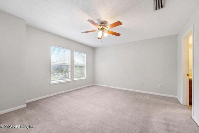 empty room with light carpet, a textured ceiling, and ceiling fan