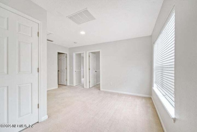 carpeted spare room with plenty of natural light