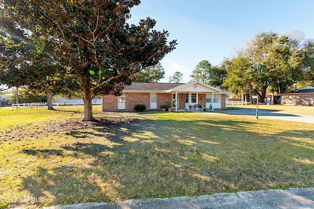 view of front facade with covered porch and a front yard