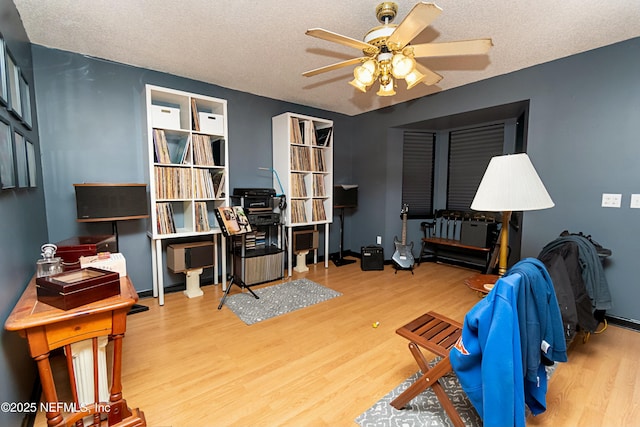 interior space with ceiling fan, hardwood / wood-style floors, and a textured ceiling