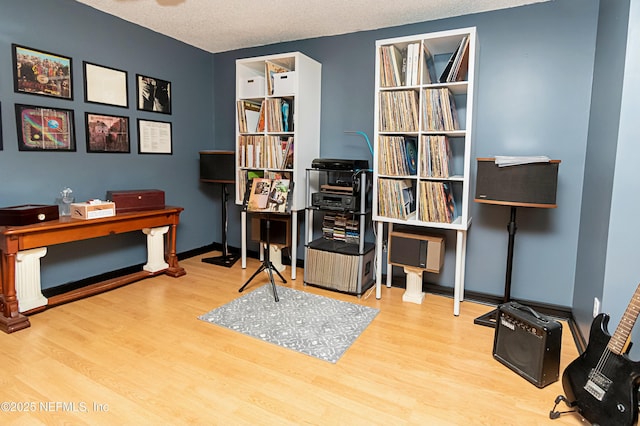 office area with a textured ceiling and light hardwood / wood-style floors