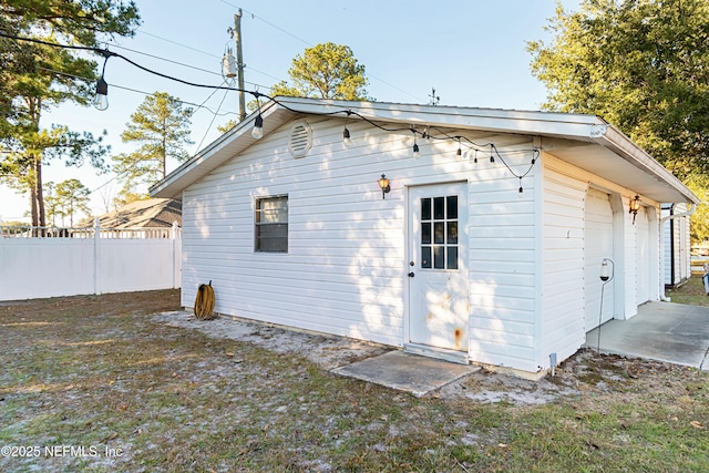 view of side of home with a garage and an outdoor structure