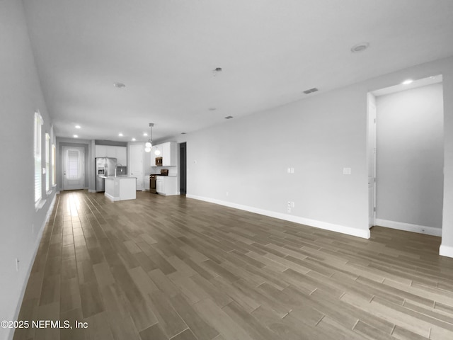 unfurnished living room featuring hardwood / wood-style floors