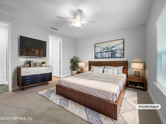 bedroom with multiple windows, light carpet, and ceiling fan