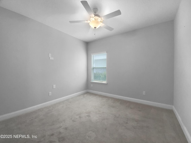 unfurnished room featuring ceiling fan and carpet