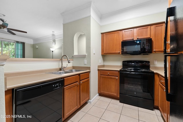 kitchen with light tile patterned floors, sink, ornamental molding, and black appliances