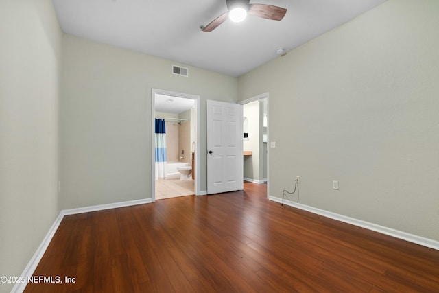 unfurnished bedroom with ceiling fan, hardwood / wood-style floors, and ensuite bathroom