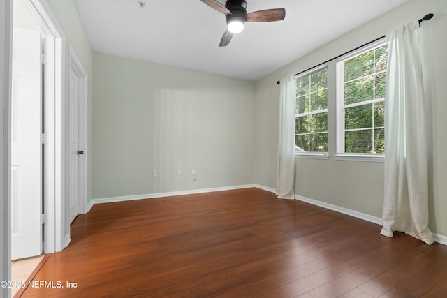 unfurnished bedroom featuring dark hardwood / wood-style floors and ceiling fan