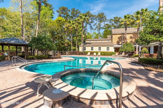 view of swimming pool featuring a gazebo, a patio, and a hot tub