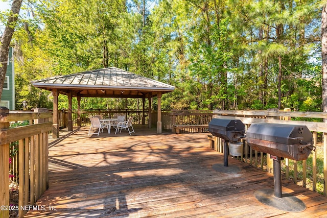 wooden deck with a gazebo and grilling area