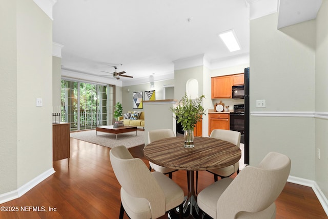 dining space featuring hardwood / wood-style flooring, ceiling fan, and ornamental molding