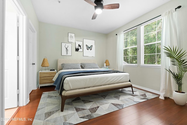 bedroom with wood-type flooring and ceiling fan