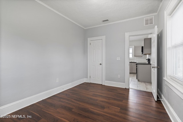 unfurnished bedroom featuring multiple windows, crown molding, and dark hardwood / wood-style floors