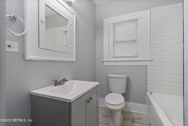 bathroom featuring vanity, toilet, and a bathtub