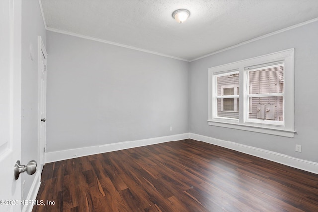 spare room with a textured ceiling, dark hardwood / wood-style floors, and ornamental molding