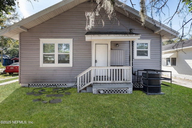 bungalow-style home with a front lawn