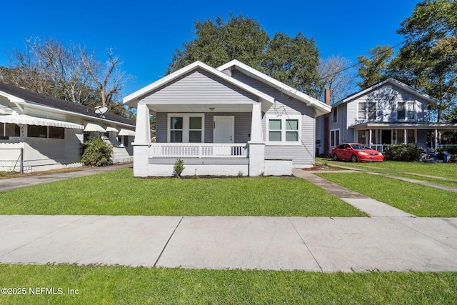 view of front of house with a porch and a front yard