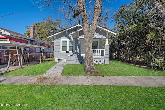 bungalow-style house featuring covered porch and a front lawn