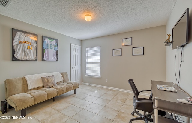 home office featuring light tile patterned flooring and a textured ceiling