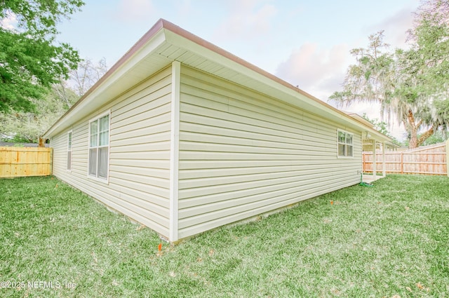 view of property exterior with a lawn