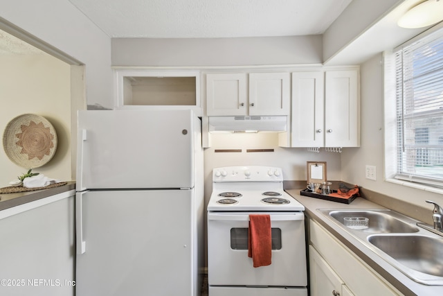 kitchen featuring sink, white cabinets, and white appliances