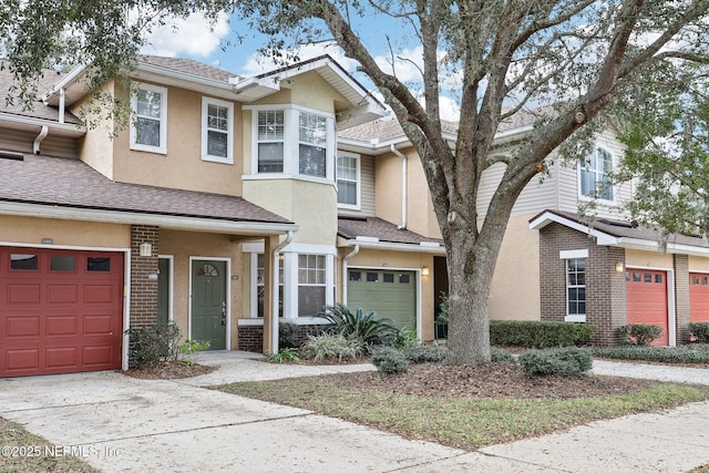 townhome / multi-family property featuring a garage