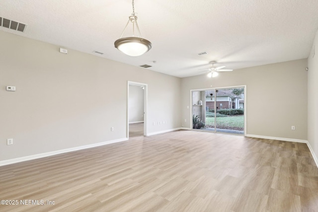 spare room with ceiling fan, a textured ceiling, and light hardwood / wood-style floors