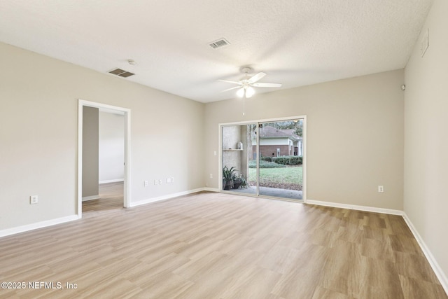 spare room featuring ceiling fan, a textured ceiling, and light hardwood / wood-style flooring