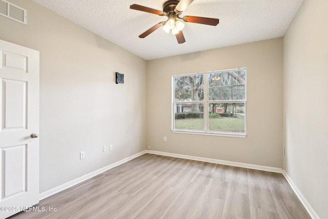 unfurnished room with ceiling fan, a textured ceiling, and light hardwood / wood-style floors