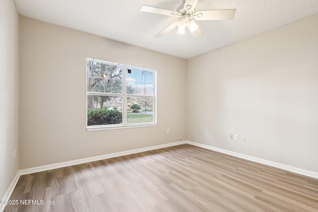 unfurnished room with a textured ceiling, ceiling fan, and light wood-type flooring