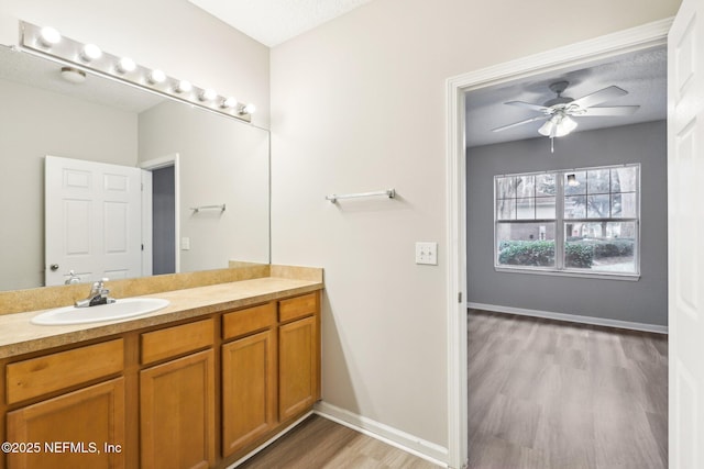 bathroom featuring vanity, wood-type flooring, and ceiling fan