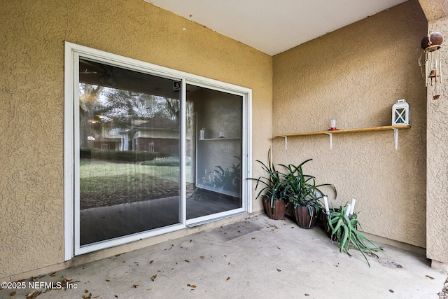 entrance to property featuring a patio area