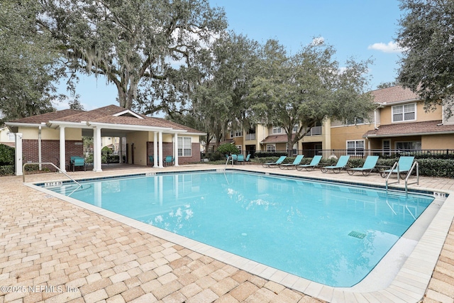 view of swimming pool with a patio area