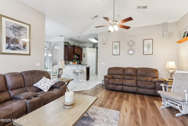 living room featuring vaulted ceiling, ceiling fan, and light hardwood / wood-style floors