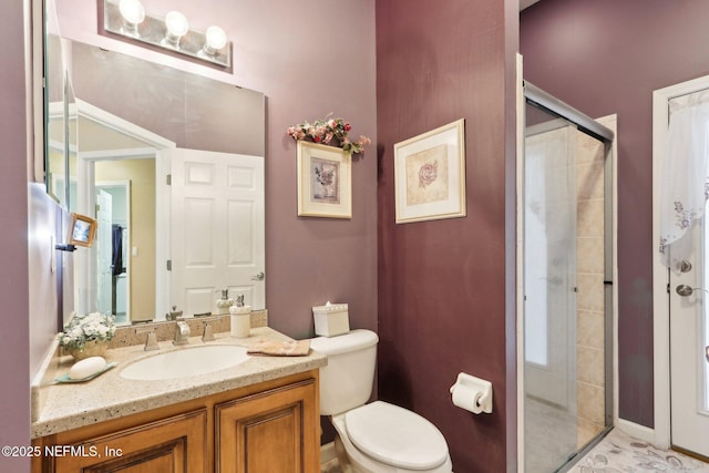 bathroom with vanity, toilet, and walk in shower