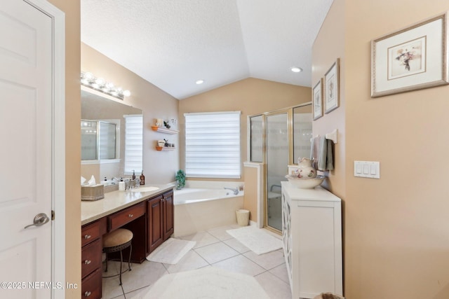 bathroom featuring vaulted ceiling, tile patterned flooring, vanity, separate shower and tub, and a textured ceiling